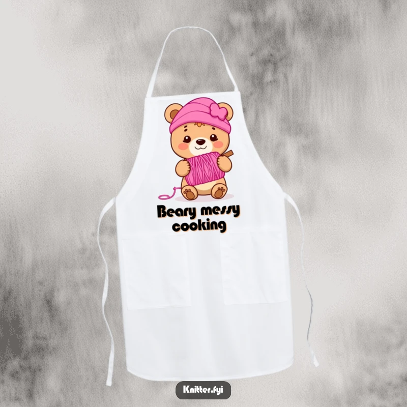 Funny bear cub apron holding a spool of vibrant pink yarn, smiling, perfect for adding kitchen or crafting humor.