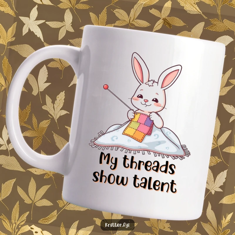 Funny mug with a happy rabbit character using a giant needle to sew a colorful patch onto a blanket, showcasing delightful crafting joy.