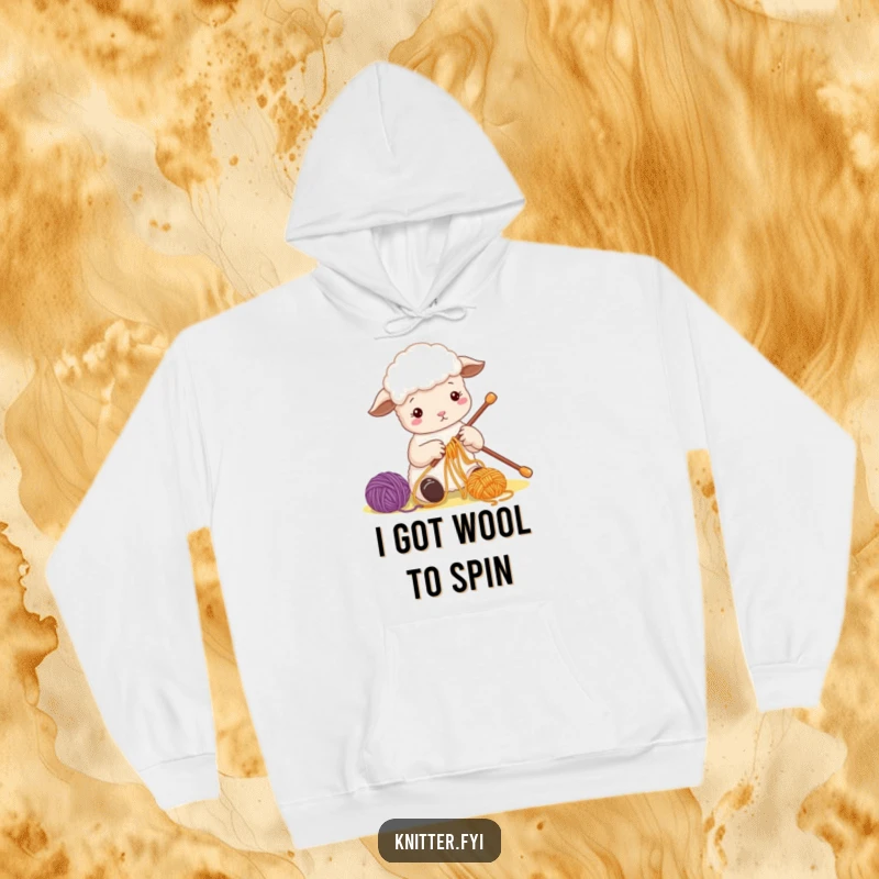 Funny Sheep Hoodie with a cute sheep character busily threading colorful yarn onto a large needle, perfect for cozy crafters.