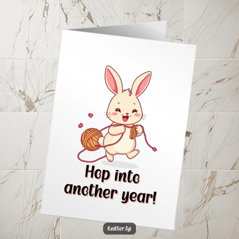 Funny free printable birthday card of a cheerful rabbit with yarn trailing, hopping playfully while knitting.