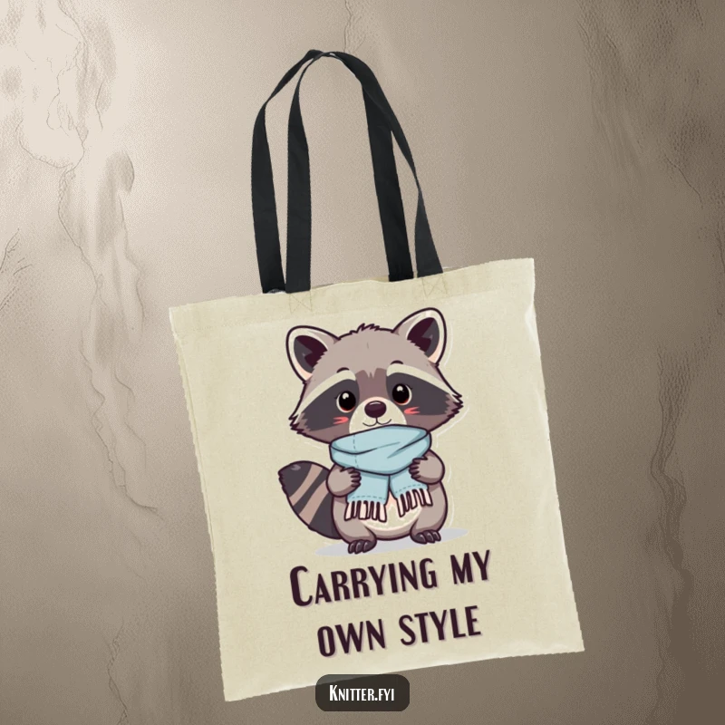 Funny Kawaii raccoon character proudly displaying a tiny, perfectly stitched scarf it just finished, a practical and humorous tote bag.